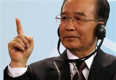 China's Premier Wen gestures as he addresses a news conference with German Chancellor Merkel at the Chancellery in Berlin