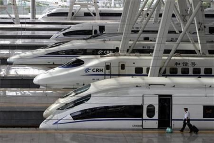 A train employee prepares to enter a CRH (China Railway High-speed) Harmony bullet train at Beijing South Railway Station