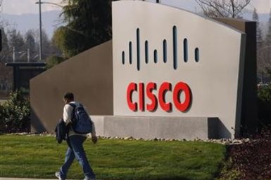 A pedestrian walks past the Cisco logo at the technology company&#039;s campus in San Jose