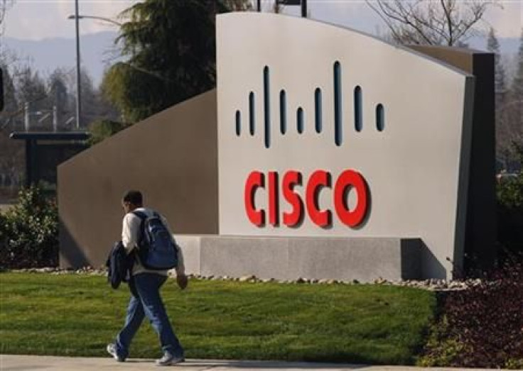 A pedestrian walks past the Cisco logo at the technology company&#039;s campus in San Jose