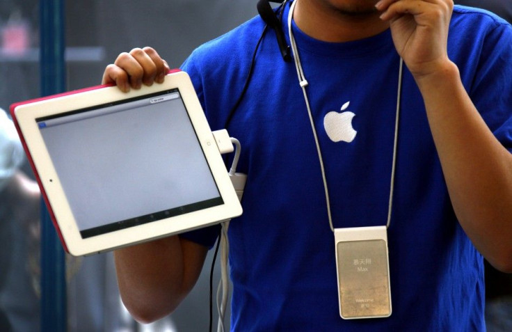 An Apple store employee gives a class on how to use the new iPad 2 during the China launch at an Apple Store in central Beijing