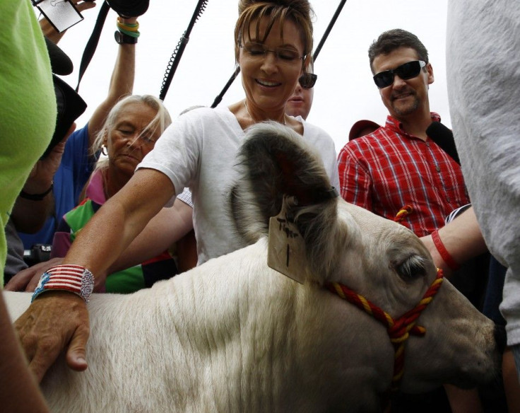 Former Governor of Alaska Sarah Palin and her husband Todd look at a bull calf during a visit to the Iowa State Fair in Des Moines