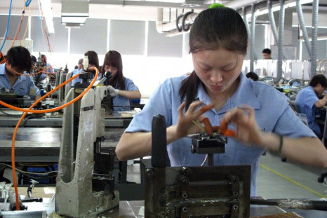 Workers at Amphenol factory weave intricate cables for western brands in China&#039;s Guangzhou