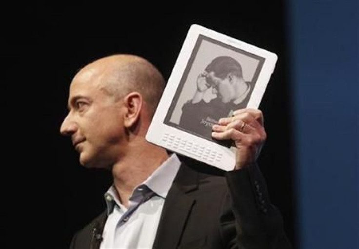 Amazon.com founder and CEO Jeff Bezos holds the new Kindle DX electronic reader at a news conference where the device was introduced in New York