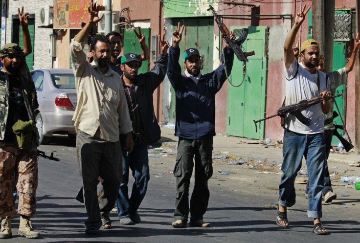 Libyan rebel fighters celebrate after taking partial control of the coastal town of Zawiyah