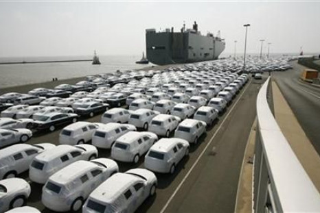 New VW cars are covered with protective covers before loaded for export on a transport ship at the harbour in Emden