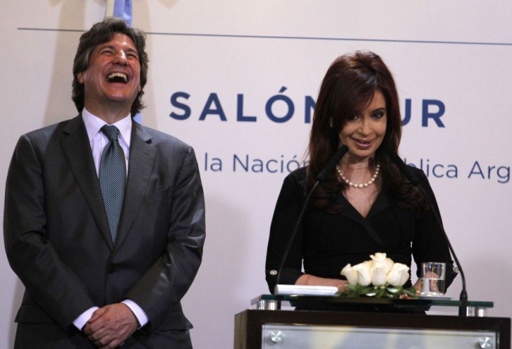 Argentina&#039;s Economy Minister Amado Boudou laughs next to President Cristina Fernandez de Kirchner during a news conference in Buenos Aires