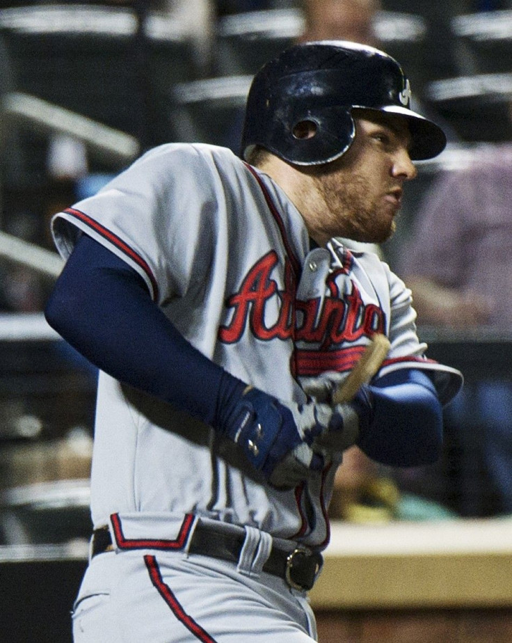 Atlanta Braves&#039; Freeman breaks his bat as he hits a single to drive in a run against the New York Mets in New York