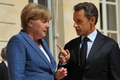 France's President Nicolas Sarkozy welcomes German Chancellor Angela Merkel as she arrives for a meeting at the Elysee Palace in Paris