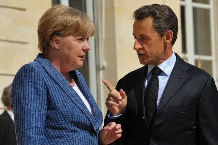 France's President Nicolas Sarkozy welcomes German Chancellor Angela Merkel as she arrives for a meeting at the Elysee Palace in Paris