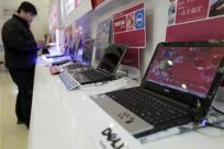 A customer looks at laptops at a Dell outlet in Beijing