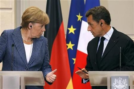 France&#039;s President Sarkozy and German Chancellor Merkel talk during a news conference at the Elysee Palace in Paris