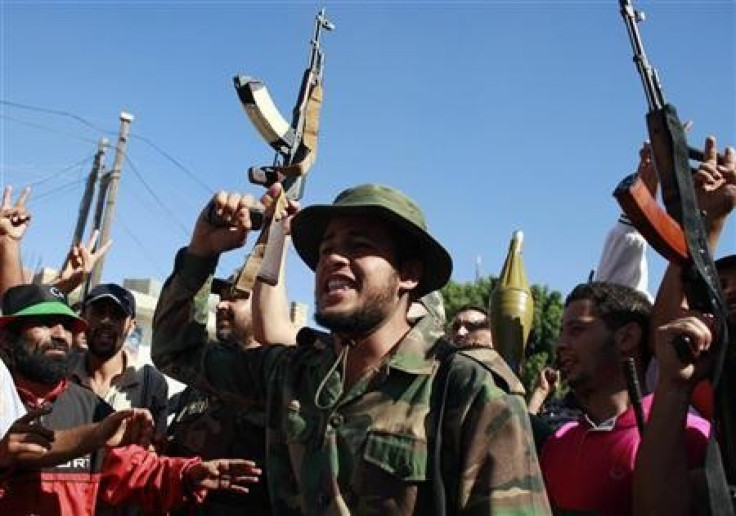 Rebel fighters celebrate after taking partial control of the coastal town of Zawiyah,