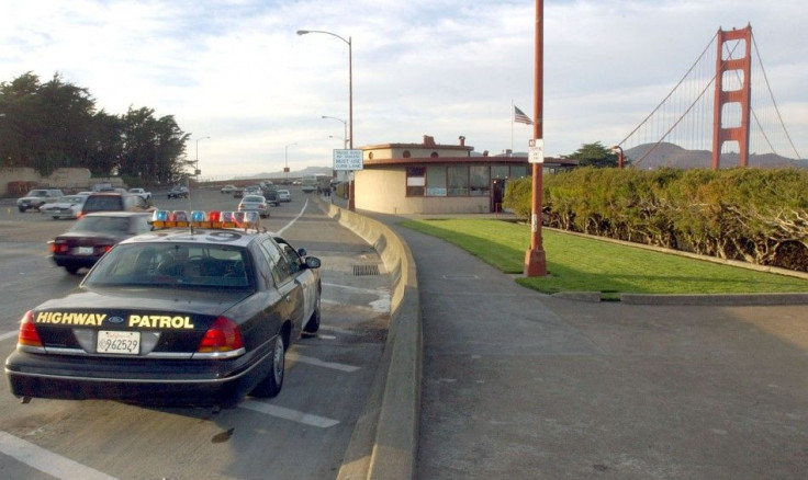 A California Highway Patrol officer stands watch at the toll plaza on the Golden Gate Bridge in San Francisco, California November 1, 2001.