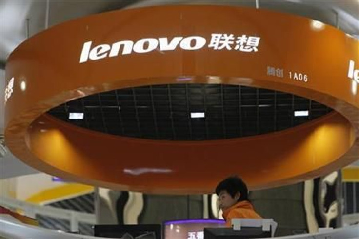 A salesperson waits for customers at a Lenovo shop in Shanghai
