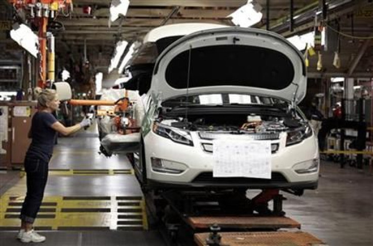 United Auto Workers union member Carrie Attwood uses an ergonomic-arm to install a front seat in a Chevrolet Volt electric vehicle at General Motors Detroit-Hamtramck assembly plant in Hamtramck