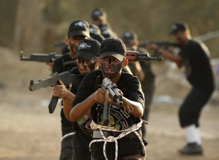 Palestinian scouts of Al-Qassam brigades demonstrate their skills during a graduation ceremony in Gaza City