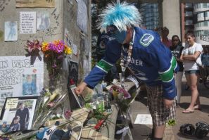 Vancouver Canucks fan pays tribute to former hockey player Rick Rypien during a gathering in Vancouver