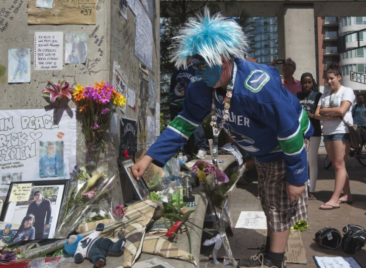 Vancouver Canucks fan pays tribute to former hockey player Rick Rypien during a gathering in Vancouver