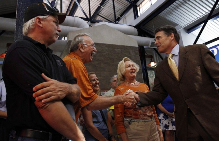 U.S. Republican presidential candidate Texas Governor Rick Perry greets people during a campaign stop in Walcott, Iowa