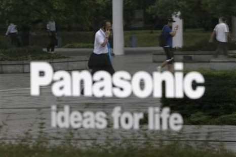 People are reflected on a sign at Panasonic Corp&#039;s showroom in Tokyo