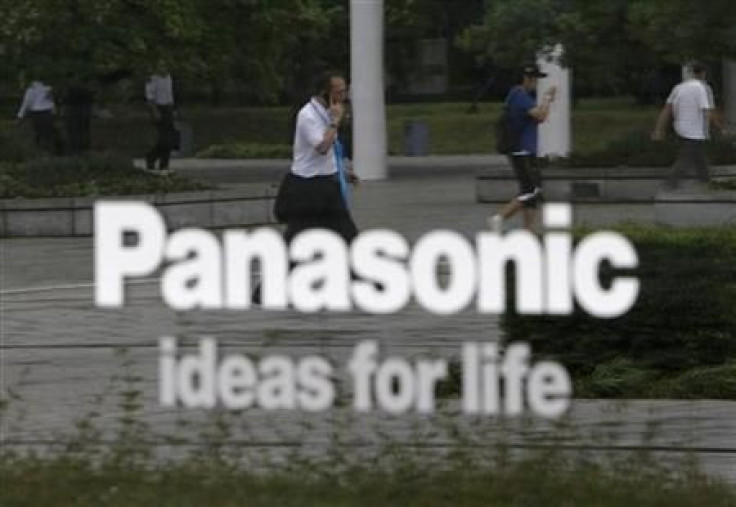 People are reflected on a sign at Panasonic Corp&#039;s showroom in Tokyo