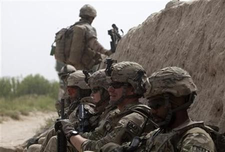Canadian and U.S. army soldiers attached to 1st Battalion, 22nd royal regiment rest during a patrol in the Panjwai district of Kandahar province in southern Afghanistan