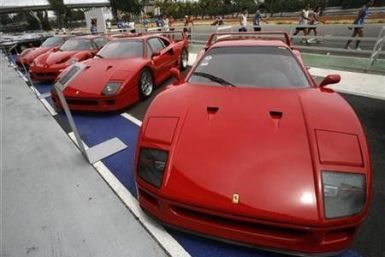 Ferrari cars, including the F40 (R and 2nd R), F50 (2nd L) and Enzo sit on display during a show of luxury cars in Singapore