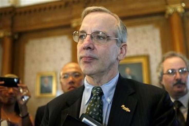 Federal Reserve Bank of New York President William C. Dudley pauses as he talks with a small business owner at the Brooklyn Chamber of Commerce in New York