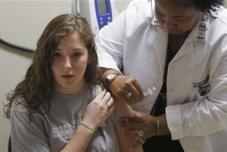 George Washington University sophomore Mariasa Mammone gets a H1N1 flu vaccine shot by Licensed Practical Nurse (LPN) Angela Adams at the Student Health Service clinic in Washington