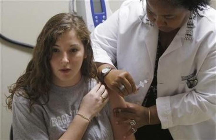 George Washington University sophomore Mariasa Mammone gets a H1N1 flu vaccine shot by Licensed Practical Nurse (LPN) Angela Adams at the Student Health Service clinic in Washington