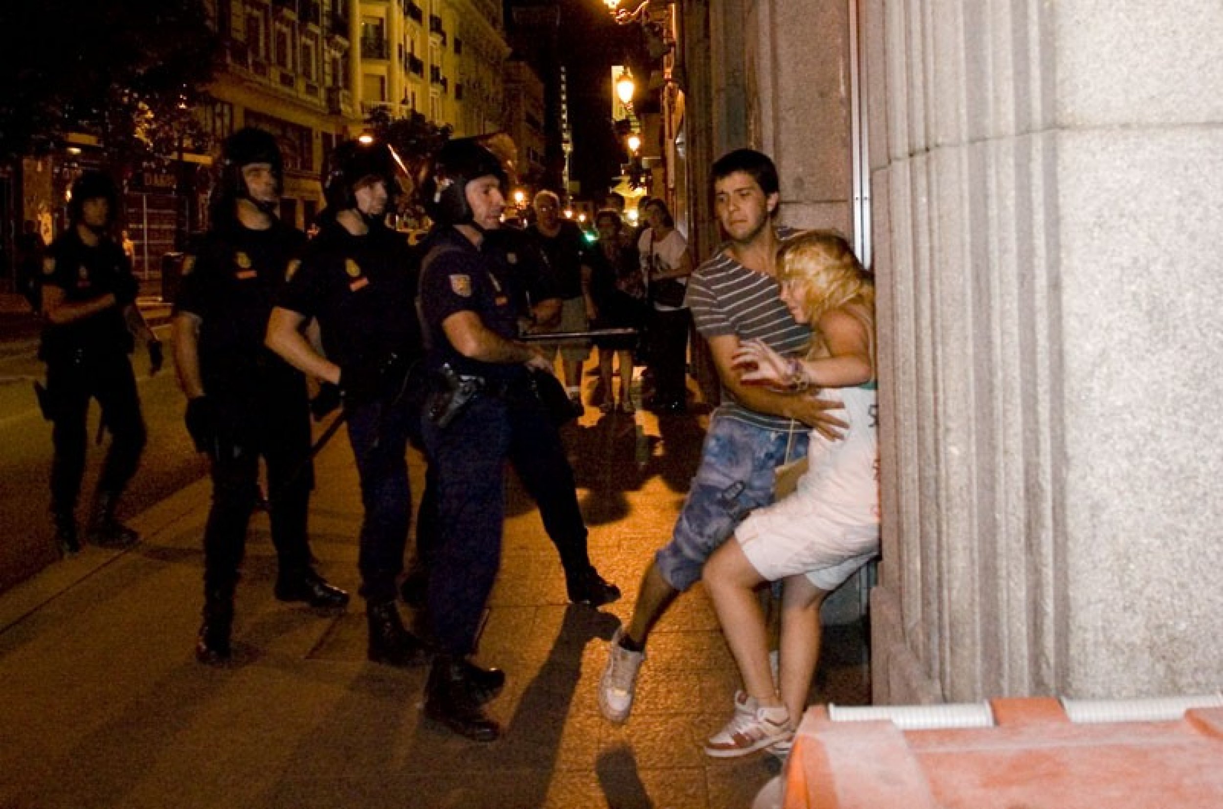 Spanish riot police assault young woman