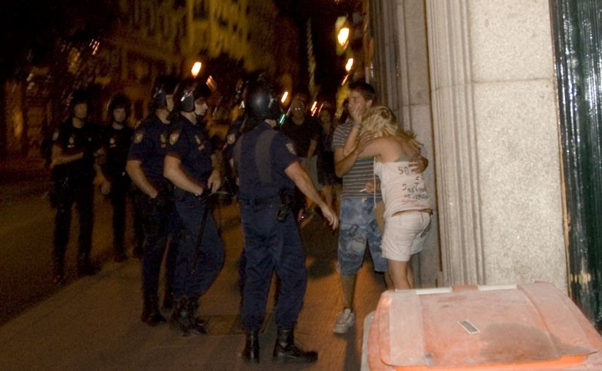 Spanish riot police assault young woman