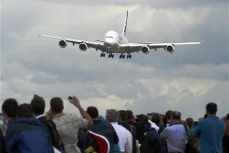 An Airbus A380 plane is watched by spectators as it lands at the Farnborough Airshow