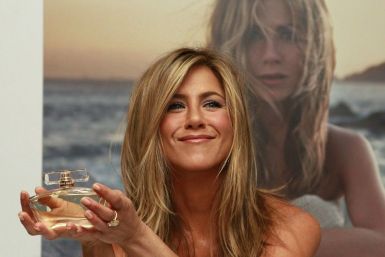 U.S. actress Jennifer Aniston poses with her fragrance &#039;Jennifer Aniston&#039; during its launch at Harrods in London