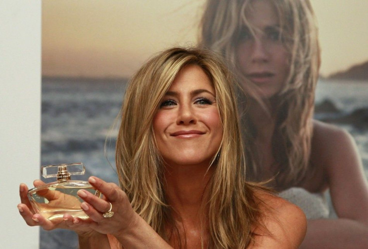 U.S. actress Jennifer Aniston poses with her fragrance &#039;Jennifer Aniston&#039; during its launch at Harrods in London