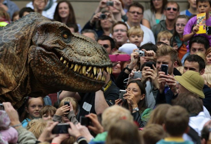Visitors photograph an animatronic Tyrannosaurus Rex at the reopening of the National Museum of Scotland after its three-year £47 million redevelopment in Edinburgh