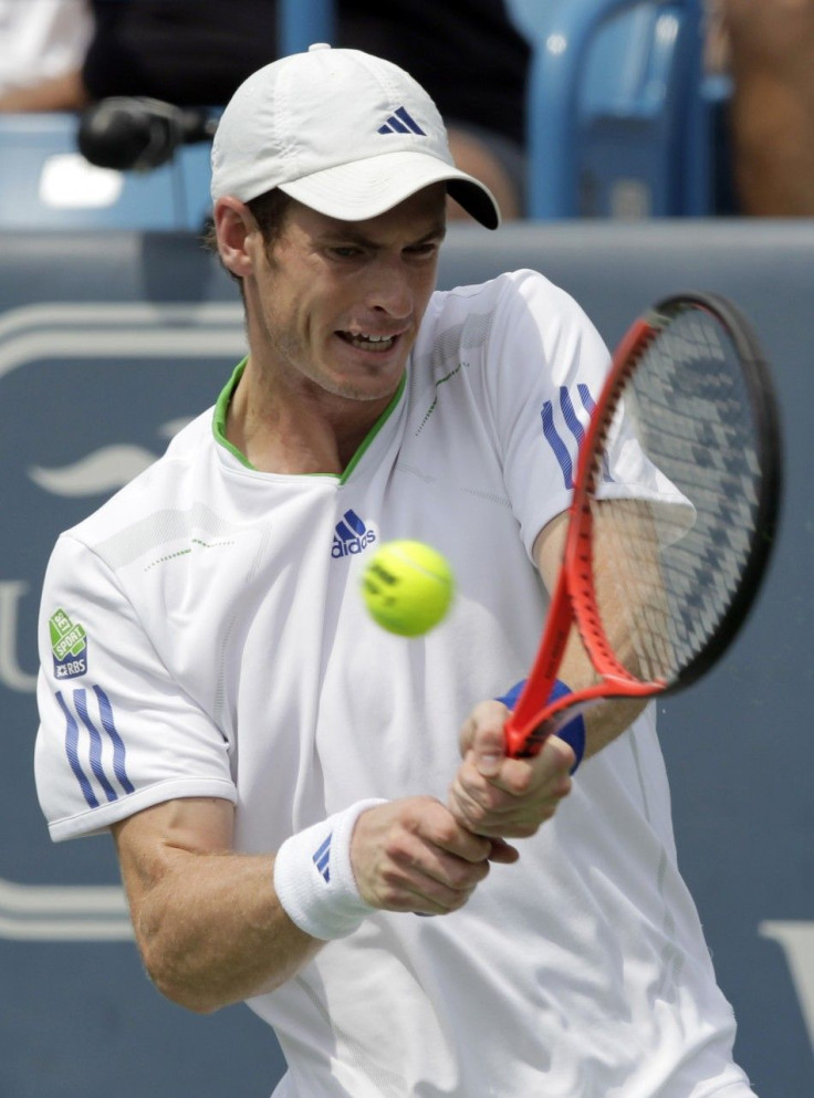 Andy Murray of Britain, hits a return to Mardy Fish of the United States, during their semifinal round match of the 2011 Cincinnati Open tennis tournament in Cincinnati