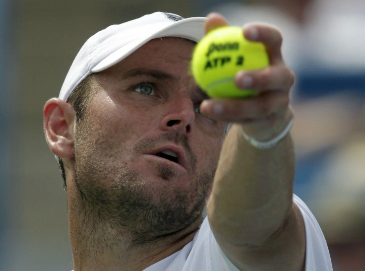 Mardy Fish of the United States, serves to Andy Murray of Britain, during their semifinal round match of the 2011 Cincinnati Open tennis tournament in Cincinnati,