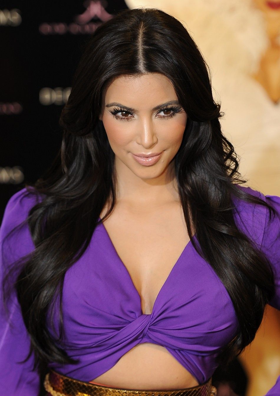 U.S. television celebrity Kim Kardashian poses for photographers as she launches her perfume at a store in central London June 8, 2011