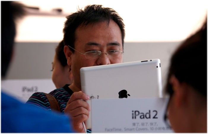 A customer looks at an iPad 2 during the China launch at an Apple Store in central Beijing May 6, 2011