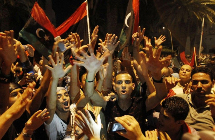 Members of the Libyan community in Tunisia gather outside the Libyan Embassy in Tunis