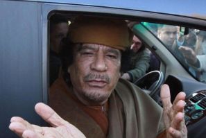 File photograph of Libyan leader Moammar Gadhafi gesturing from a car in the compound of Bab Al Azizia in Tripoli