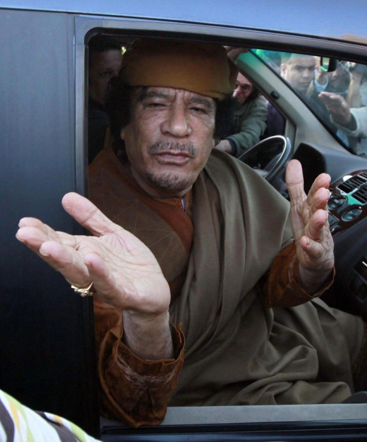 File photograph of Libyan leader Moammar Gadhafi gesturing from a car in the compound of Bab Al Azizia in Tripoli