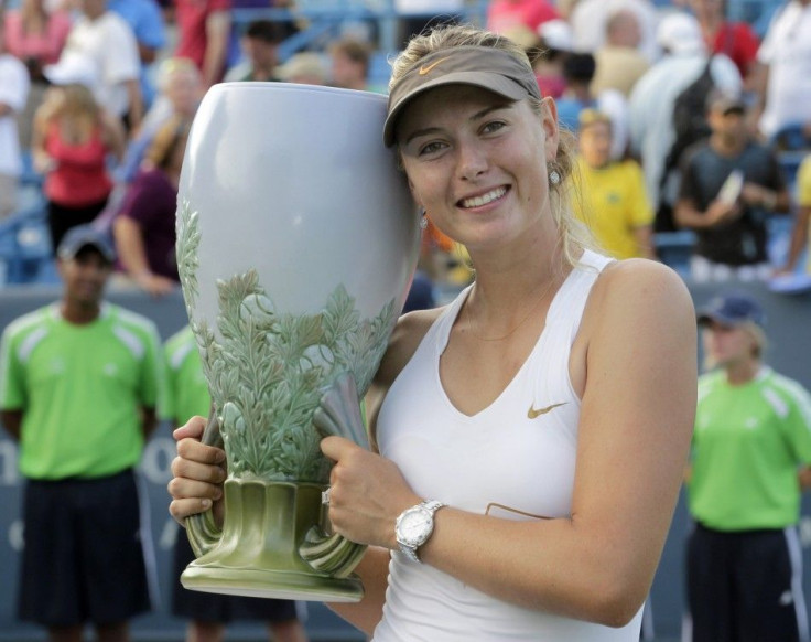Sharapova holds up the championship trophy after defeating Jankovic to win the 2011 Cincinnati Open tennis tournament in Cincinnati