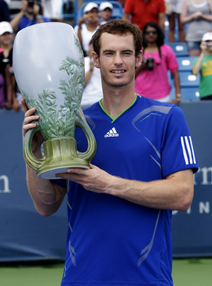 Murray of Britain holds up the championship trophy after defeating Djokovic of Serbia in the championship match of the Cincinnati Open tennis tournament