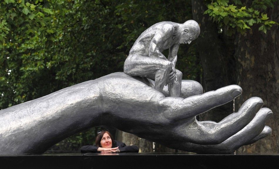 A woman views the quotHand of Godquot sculpture by Italian artist Lorenzo Quinn in central London