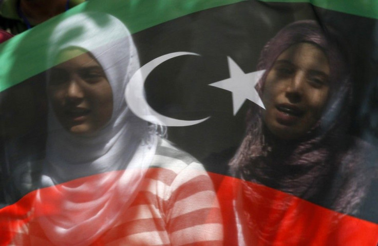 Libyans living in Turkey wave a flag of the Kingdom of Libya during a protest against Libyan leader Gaddafi outside the Libyan embassy in Ankara