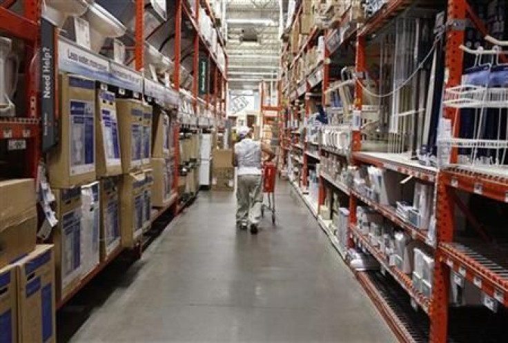 A man pushes his shopping cart down an aisle at a Home Depot store in New York