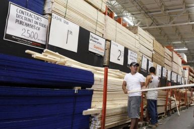 People shop for lumber at a Home Depot store in New York